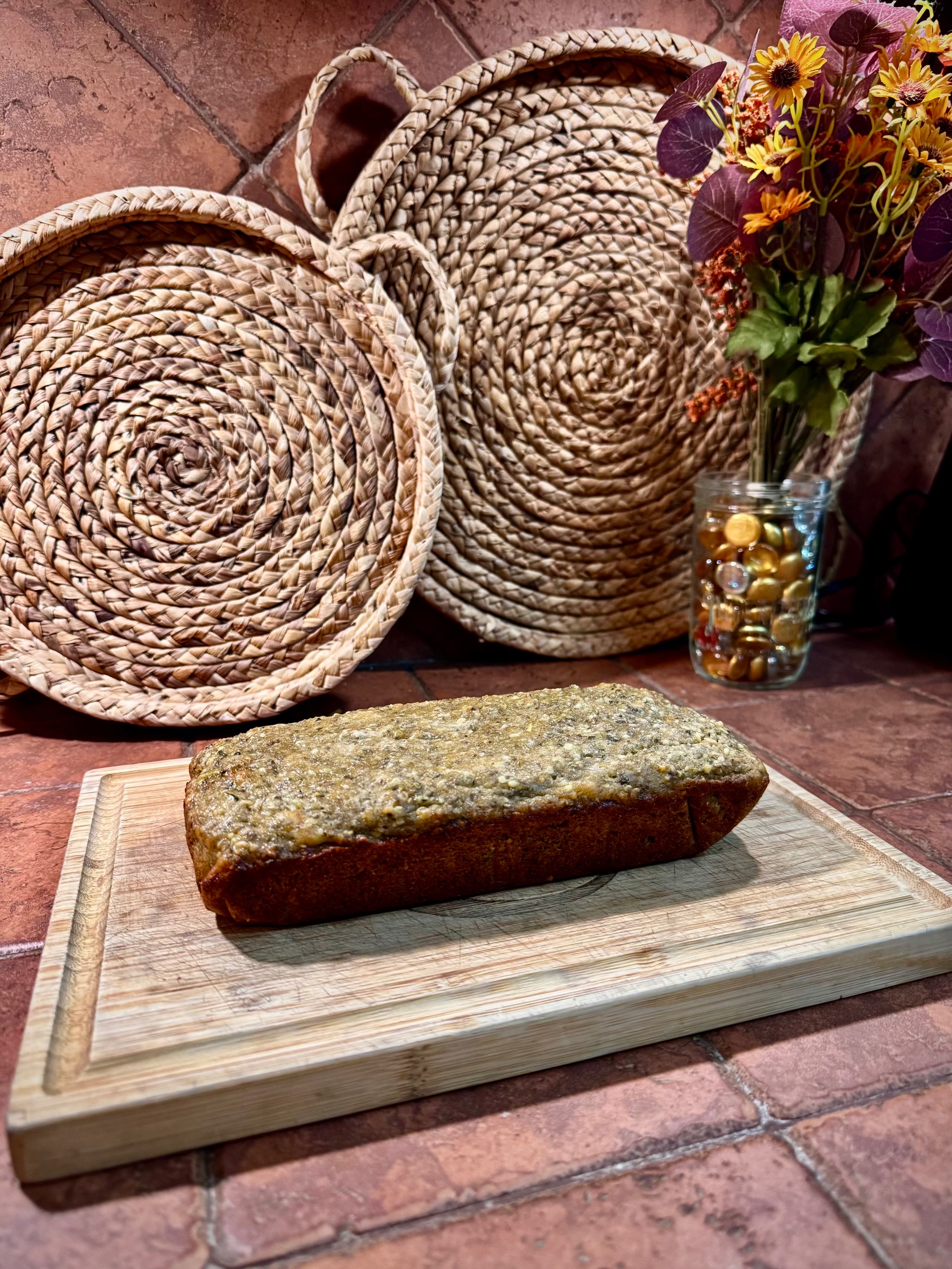 Glazed quick bread resting on a bamboo cutting board