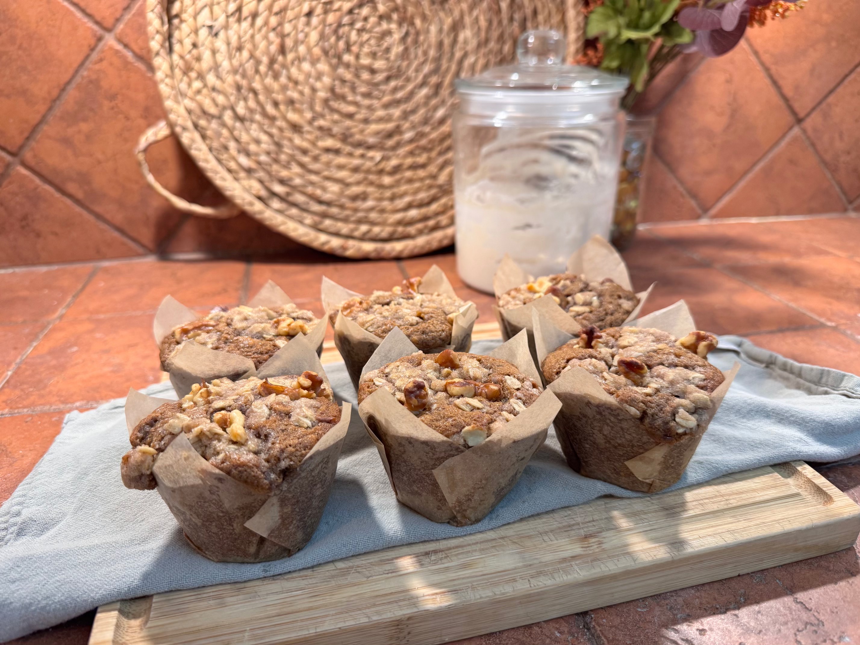 Banana walnut muffins with streusel tops on a wooden board